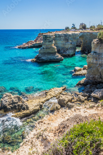 Torre Sant Andrea, Salento sea coast, Apulia, Italy. Faraglioni Melendugno. Beautiful rocky Seascape with cliffs in Puglia. Blue turquoise saturated clear water. Bright Summer day.