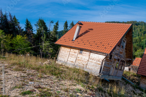 Damaged wooden house in mountains after landslide