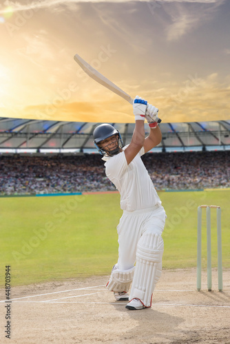 Cricketer batsman hitting a shot