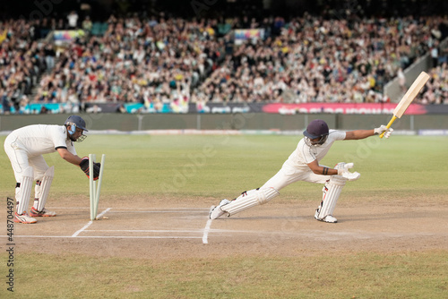 Batsman is Stumped by Wicket Keeper During a match in the stadium