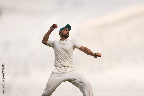 A cricket fielder throws a cricket ball in the Ground
