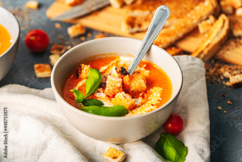 Tomato soup. Tomato creme with basil and bread. Bowl with italian tomato soup. 