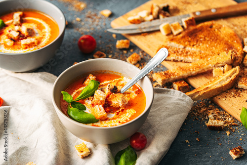 Tomato soup. Tomato creme with basil and bread. Bowl with italian tomato soup. 