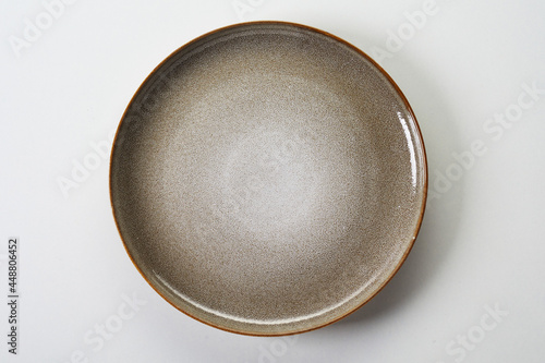 Flat ceramic plate on white background