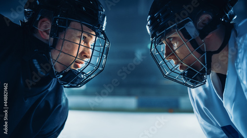 Ice Hockey Rink Arena Game Start: Two Professional Players Aggressive Face off, Sticks Ready. Intense Competitive Game Wide of Brutal Energy, Speed, Power, Professionalism. Close-up Portrait Shot