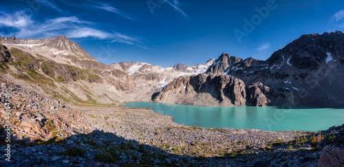 Panoramic View of Vibrant Colorful Glacier Lake up in Rocky Mountains in Canadian Nature Landscape. Sunny Summer Evening. Wedgemount Lake Hike in Whistler, British Columbia, Canada.