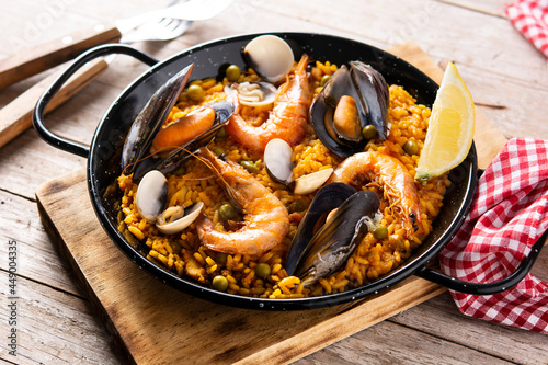 Traditional spanish seafood paella on wooden table 