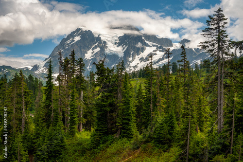 Mt. Shuksan, Washington. Shuksan rises in Whatcom County, Washington immediately to the east of Mount Baker. The mountain is a huge, sprawling mass of ridges, pinnacles, and glaciers. 