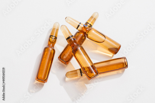 group of ampoules with serum on white background.
