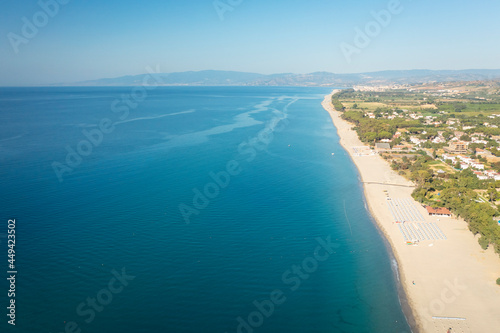 Aerial view of beautiful sea and beach at sunny day, seascape and hill mountain on backgrond, Simeri Mare, Calabria, Southern Italy