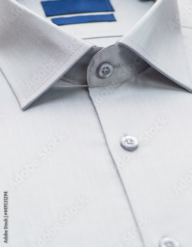 gray shirt with a focus on the collar and button, close-up
