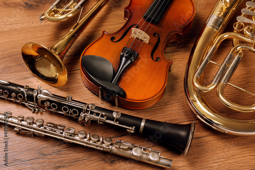 Set of different musical instruments on wooden background, closeup