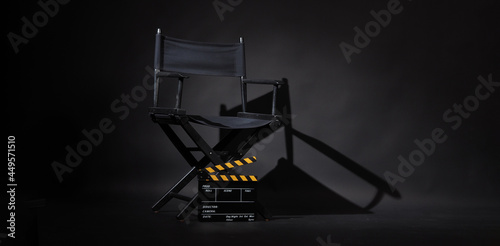 Black director chair and Clapperboard or movie slate use in video production or movie and cinema industry. It's black and yellow color..