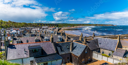 A view across the roof tops and down the coast of the town of Cullen, Scotland on a summers day