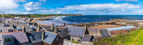 A view across the roof tops and the beach of the town of Cullen, Scotland on a summers day