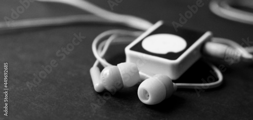Vacuum wired headphones and mini player, black and white image