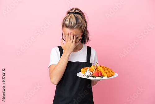 Restaurant waiter Russian girl holding waffles isolated on pink background with tired and sick expression