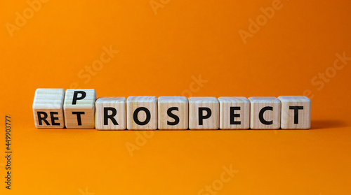 Prospect or retrospect symbol. Turned a cube and changed the word 'retrospect' to 'prospect'. Beautiful orange background. Business and prospect or retrospect concept. Copy space.