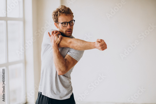 Man practicing yoga on the mat at home