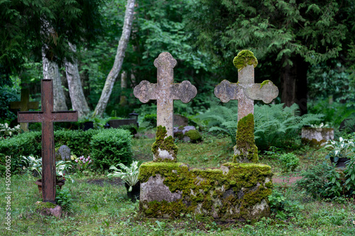 Ancient cemetery with weathered stone crosses on the quiet island of Abruka, Estonia, offering a glimpse into historical heritage and peaceful landscapes