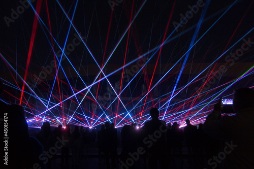 blue laser lights and people silhouettes at concert