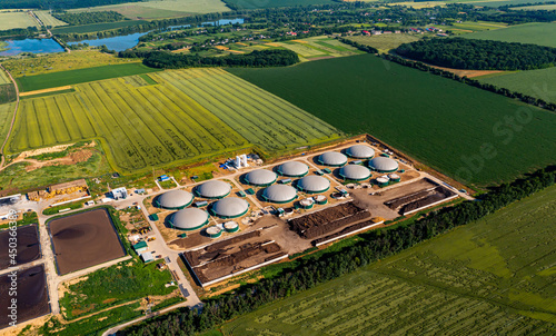 Distillation process is used to produce bio gas at station. Biogas station at the green field. View from above. Ecological production concept