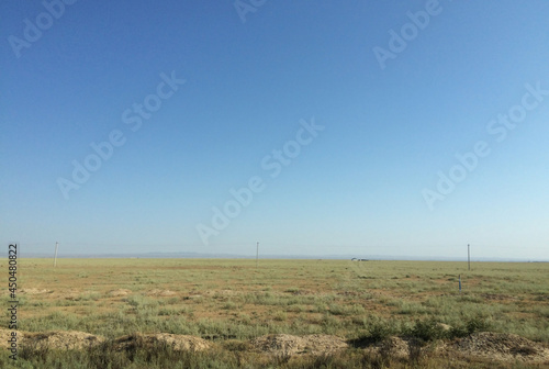 The vast steppe landscape of Kyrgyzstan on a sunny day