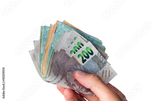 man holding lot of brazilian bank notes. Reais