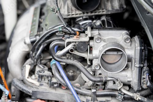 Close up old throttle Body of car in engine room with dust and Soot for repair and clean in process with engine room