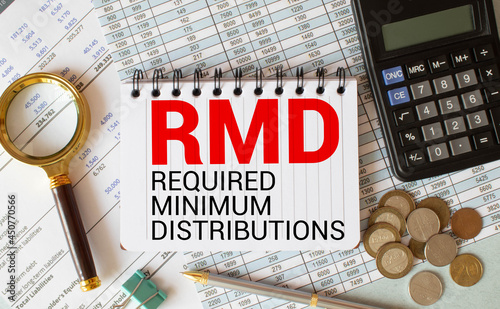 Desktop office desk, notebook, glasses, pen and documents with RMD require minimal distribution on the heading.