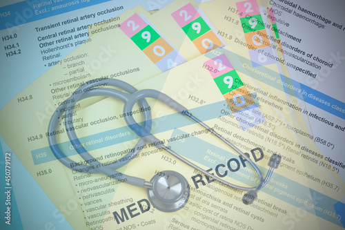 ICD-10 code book with medical record folder.