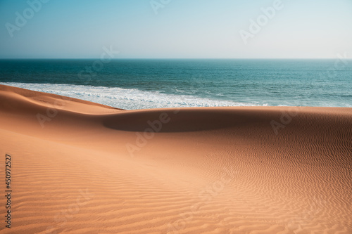 Surreal natural landscape of desert and sea. The topography of the Atlantic coast of Africa. Areas with scarce water resources. Popular travel destination in Namibia.