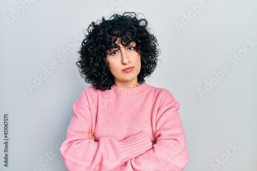 Young middle east woman wearing casual clothes skeptic and nervous, disapproving expression on face with crossed arms. negative person.