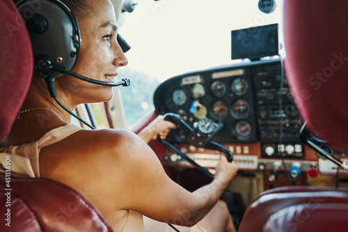 Close up of young brunette sitting in the cockpit