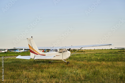 Little plane standing on the territory of airdrome