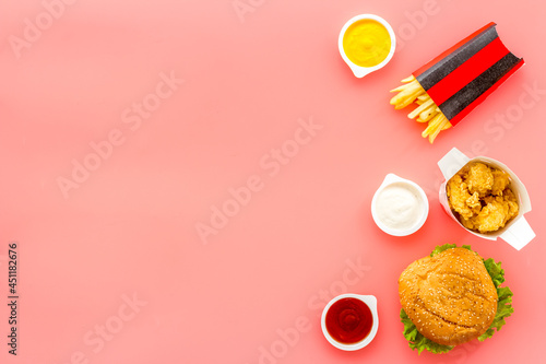 Top view of burger potatoes and chicken nuggets with sauces