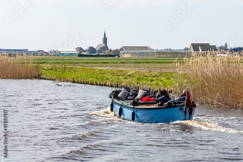 From a boat you have a beautiful view of the many fields with blooming flower bulbs near Lisse, the Netherlands