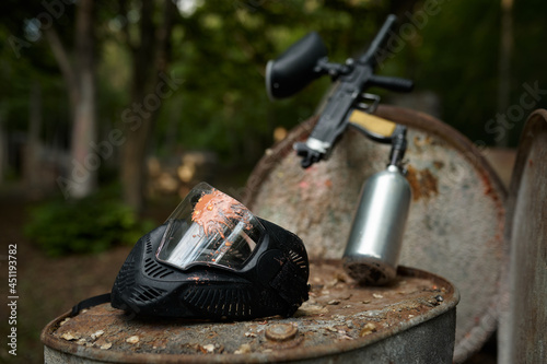 Paintball gun and protection mask closeup