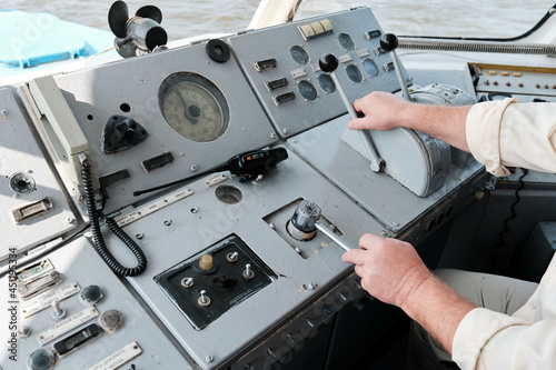 dashboard of an old Soviet river vessel. the helmsman controls the ship. Inscriptions on control panel in Russian Language. Concept of river transport and Navigation. View from cabin of captain