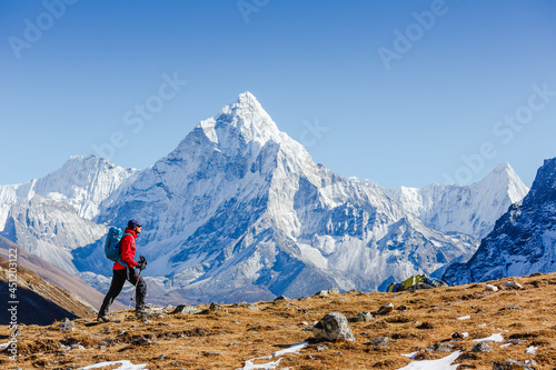 Happy hiker walking in the mountains. Himalayas, Everest Base Camp trek, Nepal