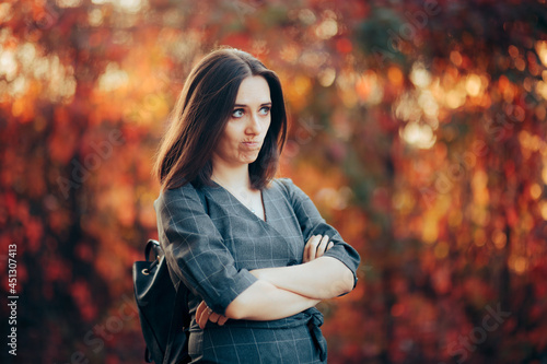 Upset Woman Standing with Arms Crossed