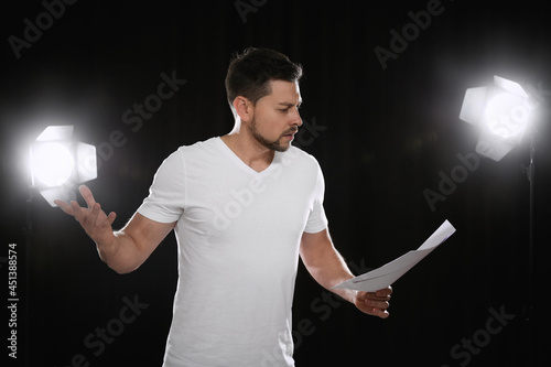 Professional actor reading his script during rehearsal in theatre