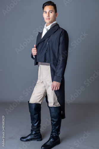 A Regency gentleman standing against a studio backdrop