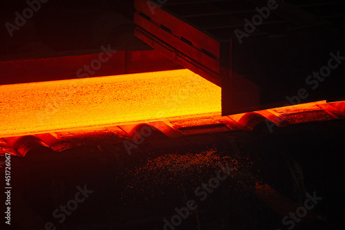 Hot rolled steel production process in the metallurgical industry. Hot metal sheet on a conveyor belt. Steel Works, Hot Rolling Mill Shop.