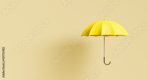 yellow umbrella on beige background with shadow