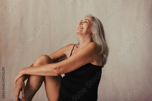 Beautiful aging woman celebrating her body