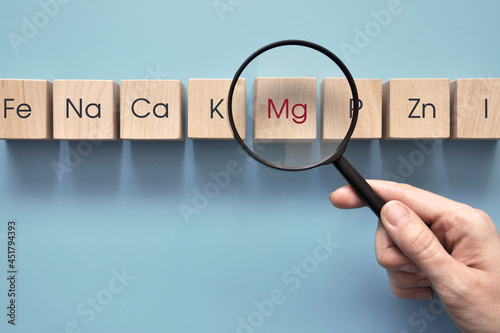 Wooden cubes with inscriptions of vitamins and macronutrients. Choosing magnesium from other useful substances 