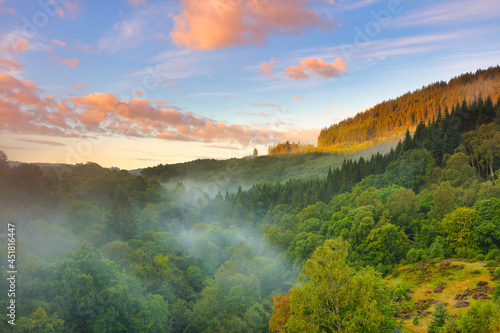 Mist rising from a Forrest at Glen Finglas, Trossachs National Park, Scotland, UK.