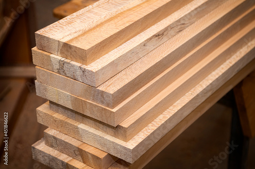 Stack of planed oak boards ready to be made into furniture