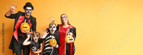 Family in Halloween costumes on color background with space for text